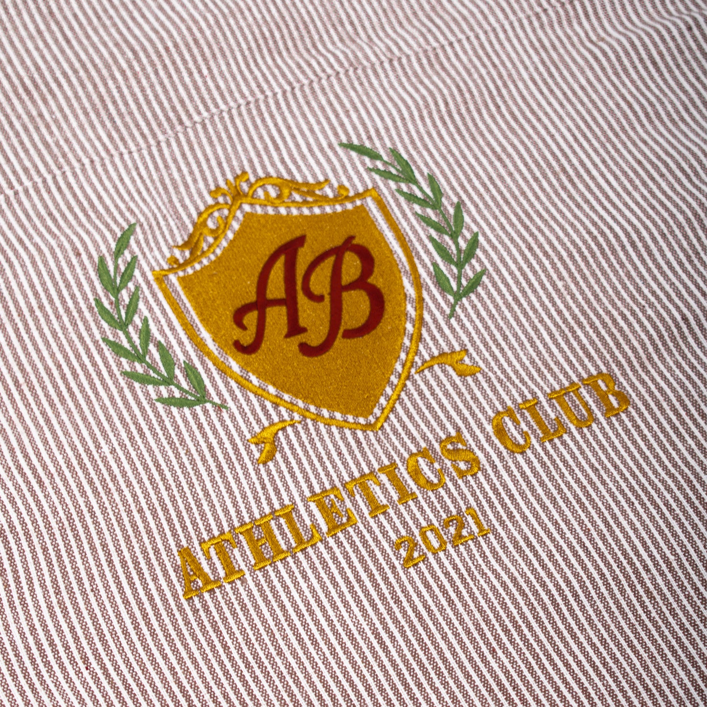 boxy cropped polo shirt | athletics club in umber stripes
