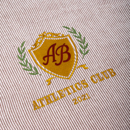 boxy cropped polo shirt | athletics club in umber stripes